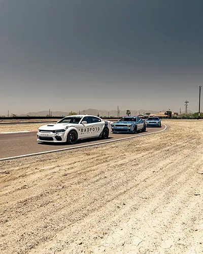 three cars lined up on track