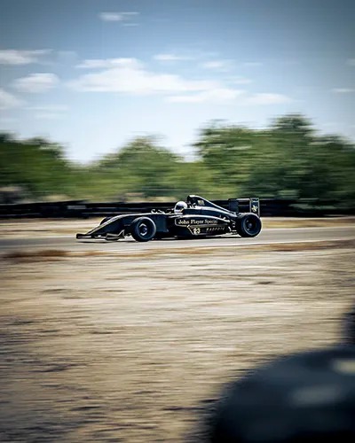 person driving Formula 4 car