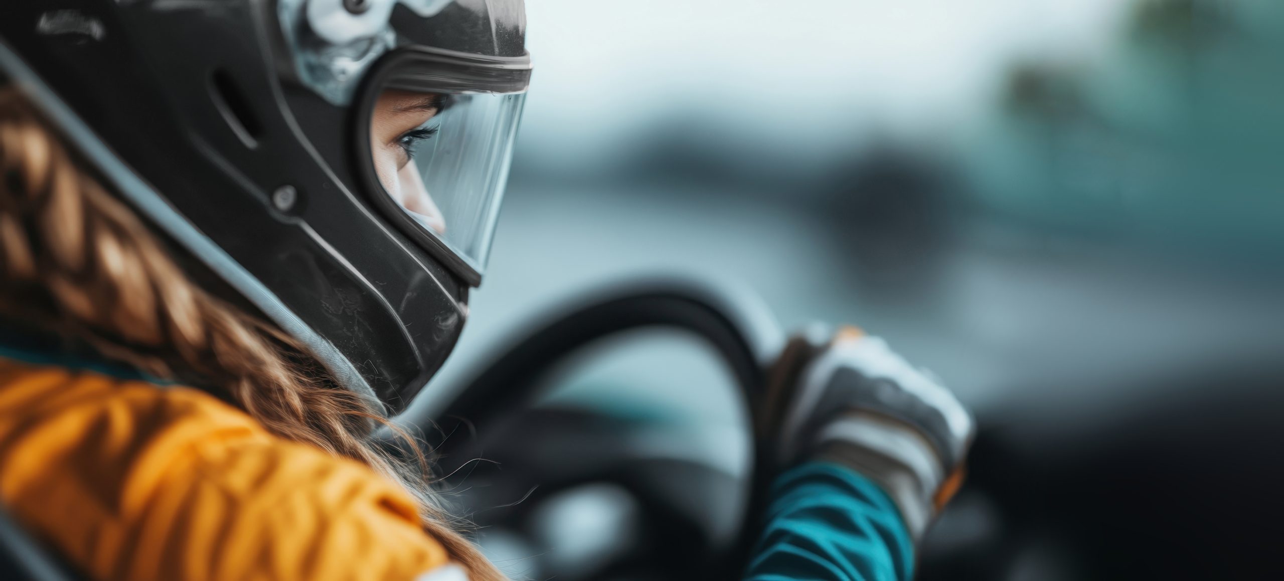 In this dynamic shot, a woman wearing a teal helmet and gloves In this dynamic shot, a woman wearing a teal helmet and gloves